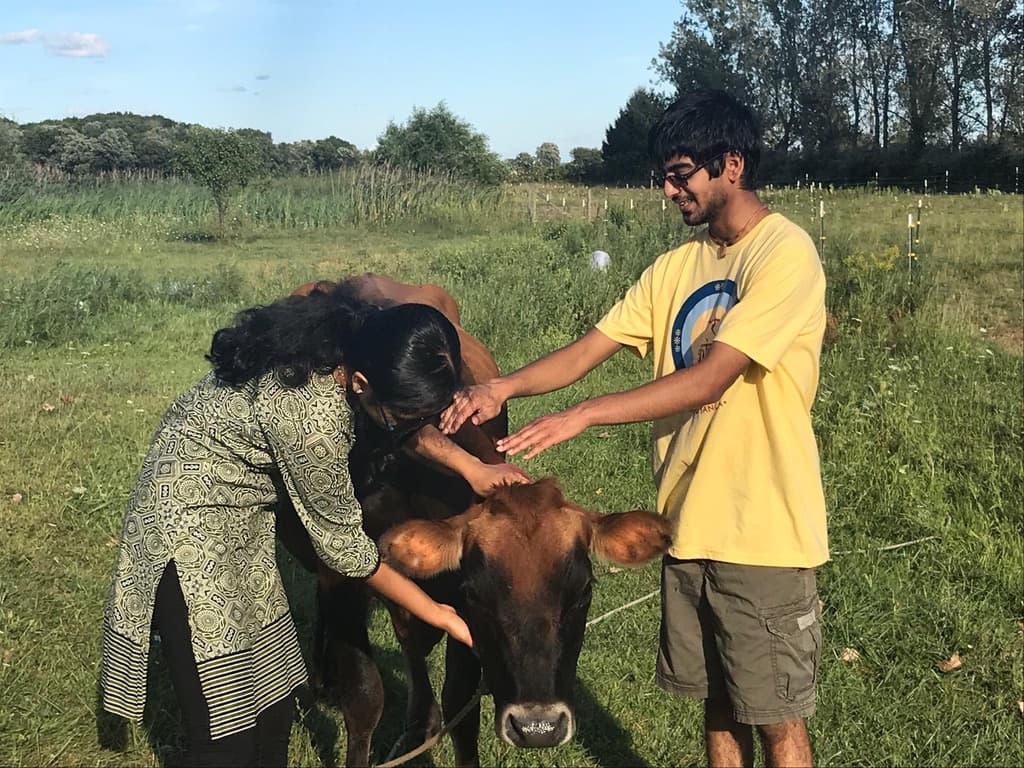 my sister and I petting a calf